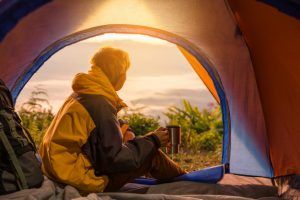 Publiplas|young man sitting tent with holding coffee cup 1150 9153